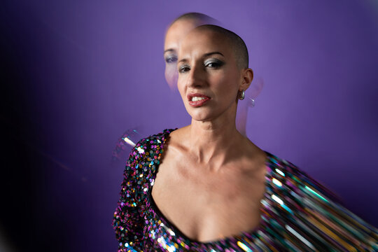 Middle aged shaved head fashion model in sequins portrait
