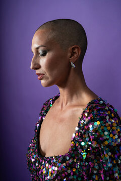 Profile portrait of shaved head fashion model in sequins