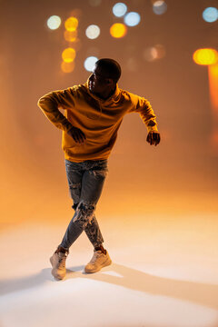 Black man urban dancer performing hip-hop at night