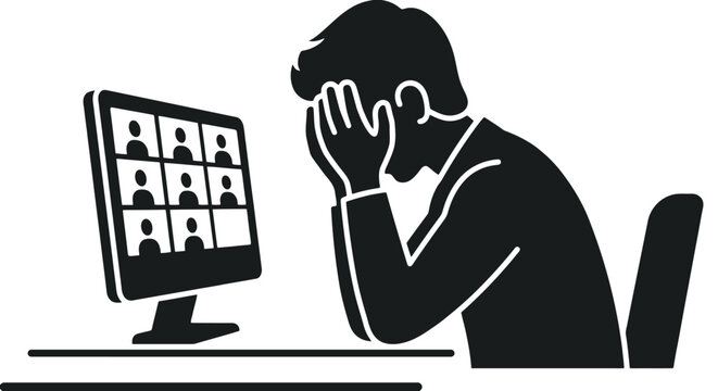 Man sitting at desk stressed by computer screen.