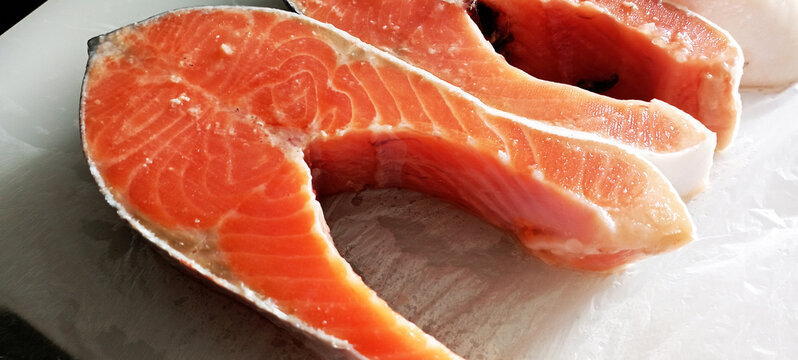 Isolated raw salmon fillet collection on a white background. Salmon, trout steak nearby. Seafood diet set.