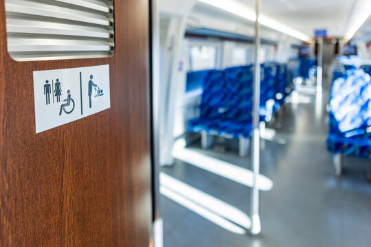 Restroom and wheelchair sign inside modern commuter train