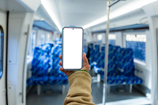 Smartphone mockup held in commuter train with empty seats