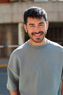 Smiling bearded man in casual sweatshirt outdoors portrait