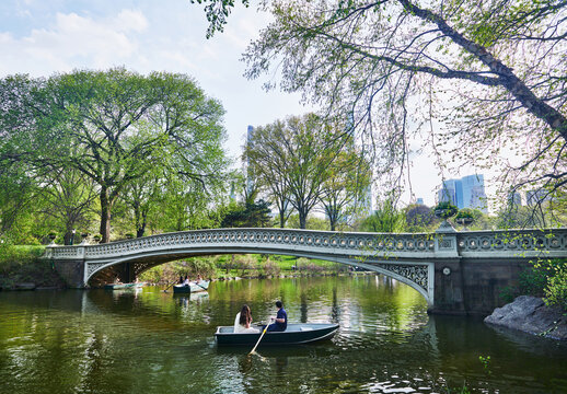 The iconic Bow Bridge in Central Park, New York City, featuring its distinctive cast-iron architecture spanning The Lake
