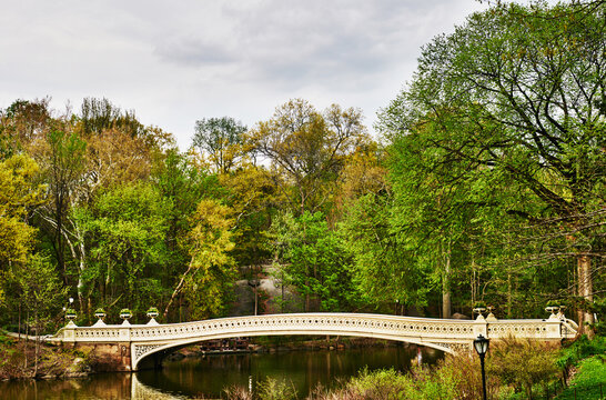 The iconic Bow Bridge in Central Park, New York City, featuring its distinctive cast-iron architecture spanning The Lake