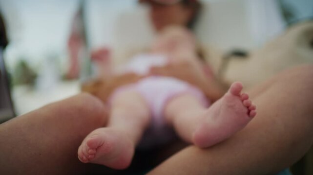 Baby's tiny feet resting on a parent's leg, emphasizing new life, family bonding, and the tenderness of motherhood