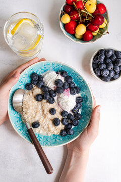 Summer breakfast with oats, blueberries, and cherries