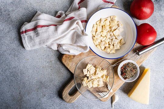 Top view of fresh ravioli with tomato and cheese ingredients