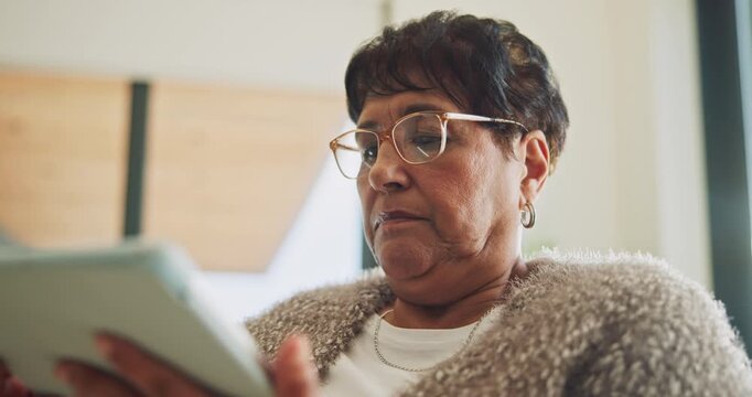 Senior, woman and scroll in house with tablet, glasses and search website for ebook on weekend break. Pensioner, person and internet in home with tech, reading news article and relax for retirement.