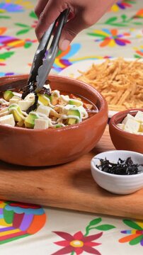 Mexican soup. Traditional tortilla soup preparation with pasilla chili strips