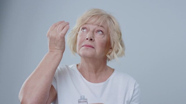 A senior woman is thoughtfully considering her medication options in a serene and calm setting