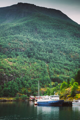 Fototapeta premium A passenger cruise ship docked in the deep, scenic Aurlandsfjord near Flam.