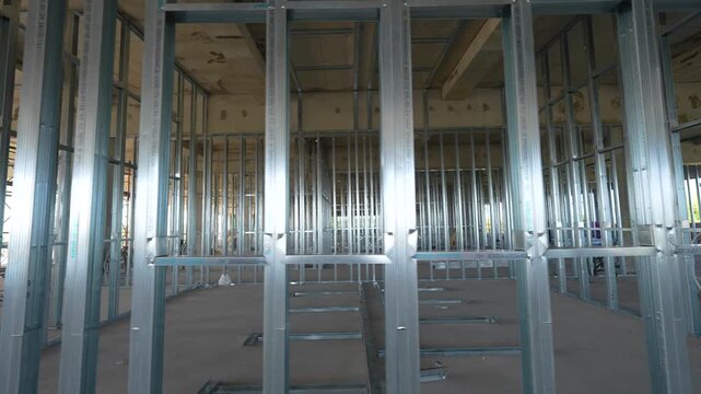 Installation of a metal partition frame in an office space under construction