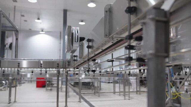 Low angle view of a metal conveyor track for empty plastic bottles