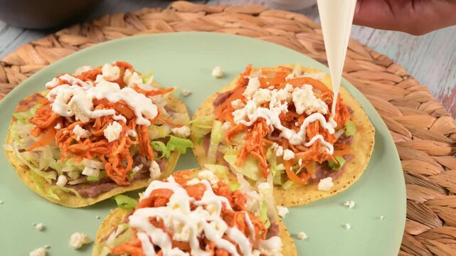 Cooking process of authentic Mexican antojitos with fresh ingredients and sour cream