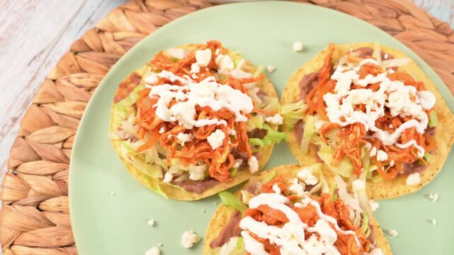 Colorful and traditional Mexican dish. Tostadas de pollo con crema y queso