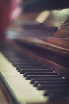 Close-up side view of a piano and piano keys