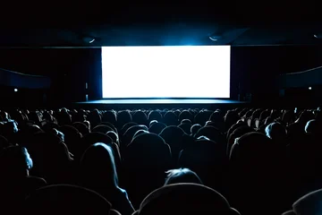 Full audience seated in a dark movie theater watching a blank white cinema screen, ideal as a mockup template for film premieres or presentations © Nikolay N. Antonov