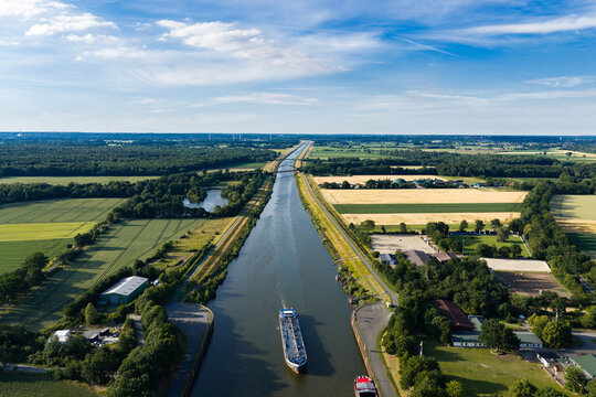Travel and logistics. Kiel canal aerial footage. Cargo ship passing through canal in Germany. Transport logistics. Canal aerial view. Maritime transport