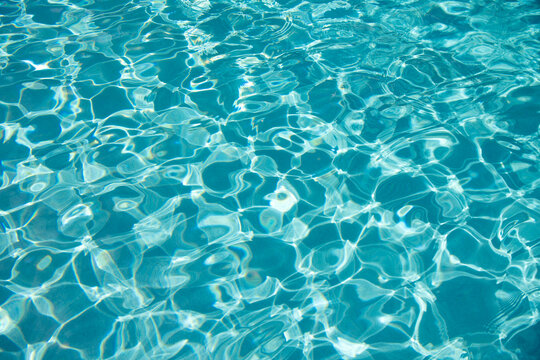 Refreshing blue swimming pool. Transparent clear water background. Water background in the swimming pool. Water in the pool. Summer vacation. Ripped water at summer vacation