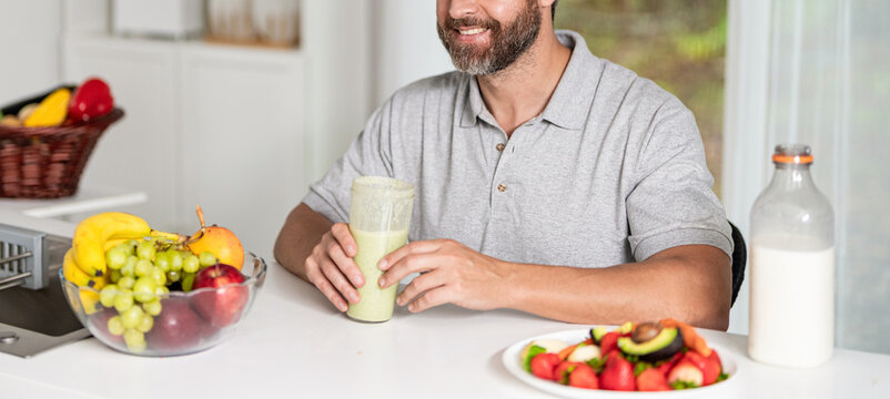 Man organic food. Morning breakfast. Healthy smoothie breakfast in morning. Man prepare breakfast in kitchen, healthy lifestyle. Hispanic man making smoothie. Diet morning food. Cold dessert