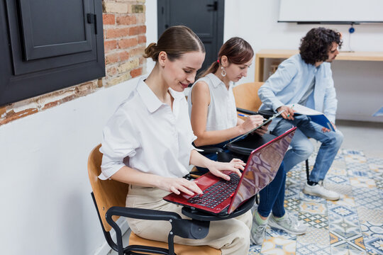 adult woman student using laptop at classroom 