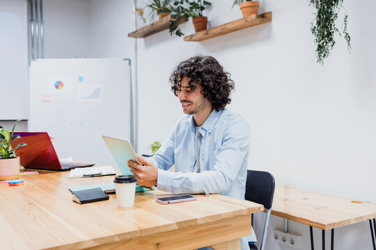 young hispanic businessman working at office in Latin America, latin male at workplace 