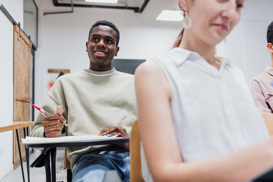 young black man university student in classroom, African american male in Education concept