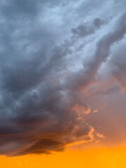 Fototapeta premium fantastic stormy sky at the sunset time, orange and purple clouds, natural sky background