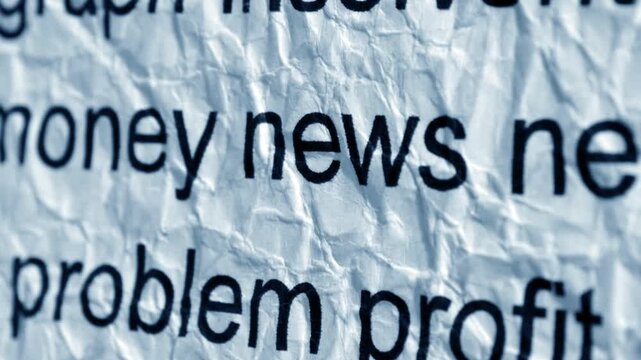 Money News Headline on Wrinkled Newspaper Background Close Up