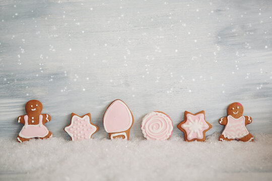 Close-up of a row of six assorted Gingerbread cookies decorated with icing