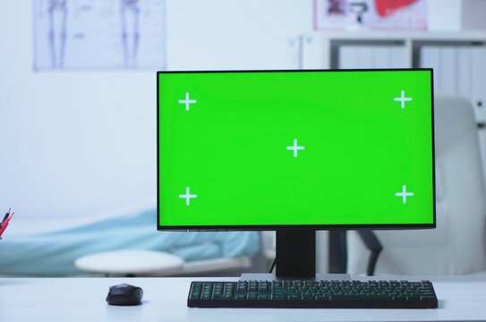 Computer desktop with green screen in a hospital cabinet, connecting clinical notes, diagnosis work and editable desktop computer display space in a practical clinical setting.