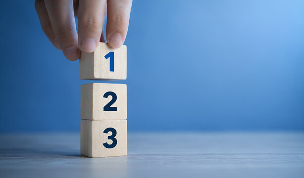 Task priority and management concept. The order of priority in any activity. Set work priority  arrange to do list. Wooden cubes with number first  second and third.