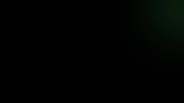 Abstract dark background with dynamic blurred green light flare. Visual effect for creative design projects and overlay.