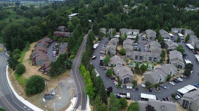 Quiet townhome cul de sacs sit adjacent to structural iron bridge spanning local waterways. Bird eye look captures relationship between established housing vital transit infrastructure in WA