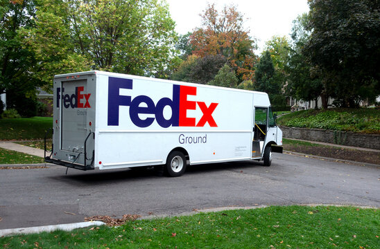 Large FedEx truck delivering packages in a neighborhood setting. St Paul Minnesota MN USA