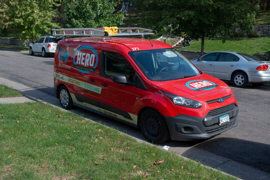 Red Hero van parked outside a home for an emergency house call specializing in plumbing, heating and cooling issues. St Paul Minnesota MN USA