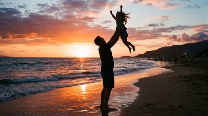 Fototapeta premium Father throws daughter in the air on a beach at sunset with ocean waves