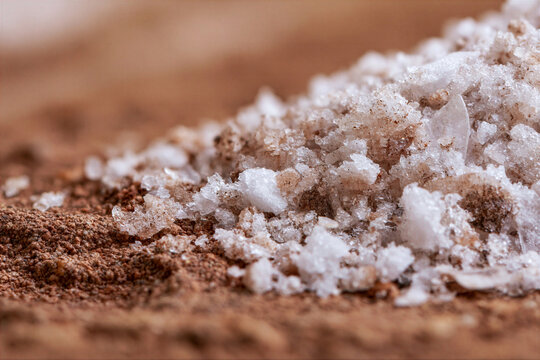 Salt losing its saltiness, being trampled underfoot on a dusty ancient road, macro texture