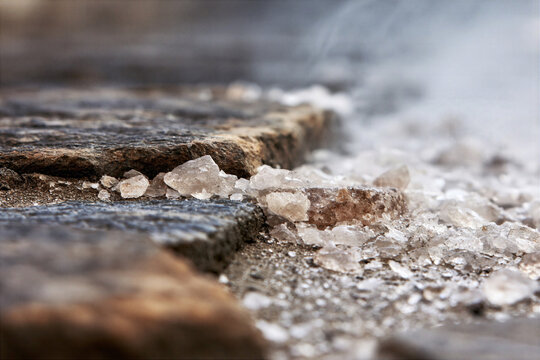 Salt losing its saltiness, being trampled underfoot on a dusty ancient road, macro texture