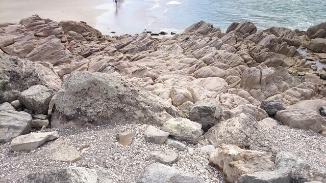 Rocky Shoreline with Weathered Granite Boulders Pebbles and Tidal Pools