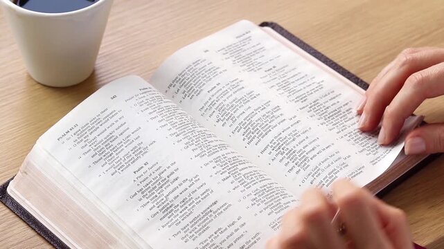 Christian person is reading from holy bible and studying the Scriptures. Biblical concept.