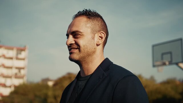 serious man starts smiling outdoor