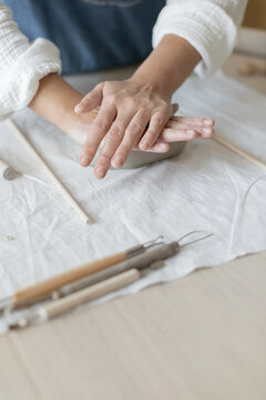 Potter artist forming clay in a focused and creative ceramic studio