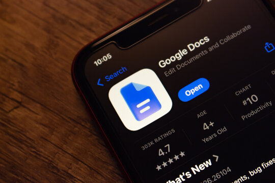 Mexico City, MEXICO - Jul 7 2026 : Google Docs app listing on the Apple App Store, on a wooden surface.