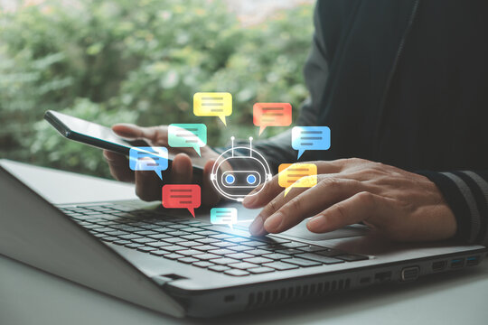 Businessman using smartphone, laptop with AI chatbot message icon. Concept of artificial intelligence, customer support automation, virtual assistant, online communication, digital service technology.
