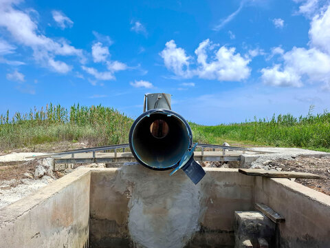 View through a black irrigation pipe in rural rice fields of Pego Spain