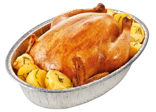 Golden whole roasted chicken with rustic rosemary potatoes in an aluminum roasting pan