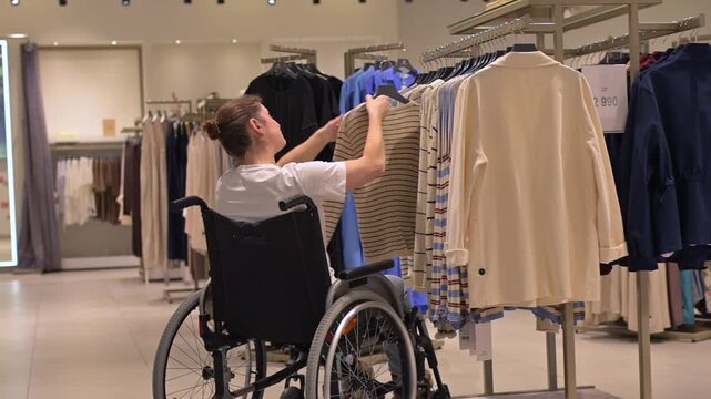 A Caucasian woman in a wheelchair shopping at a mall. 